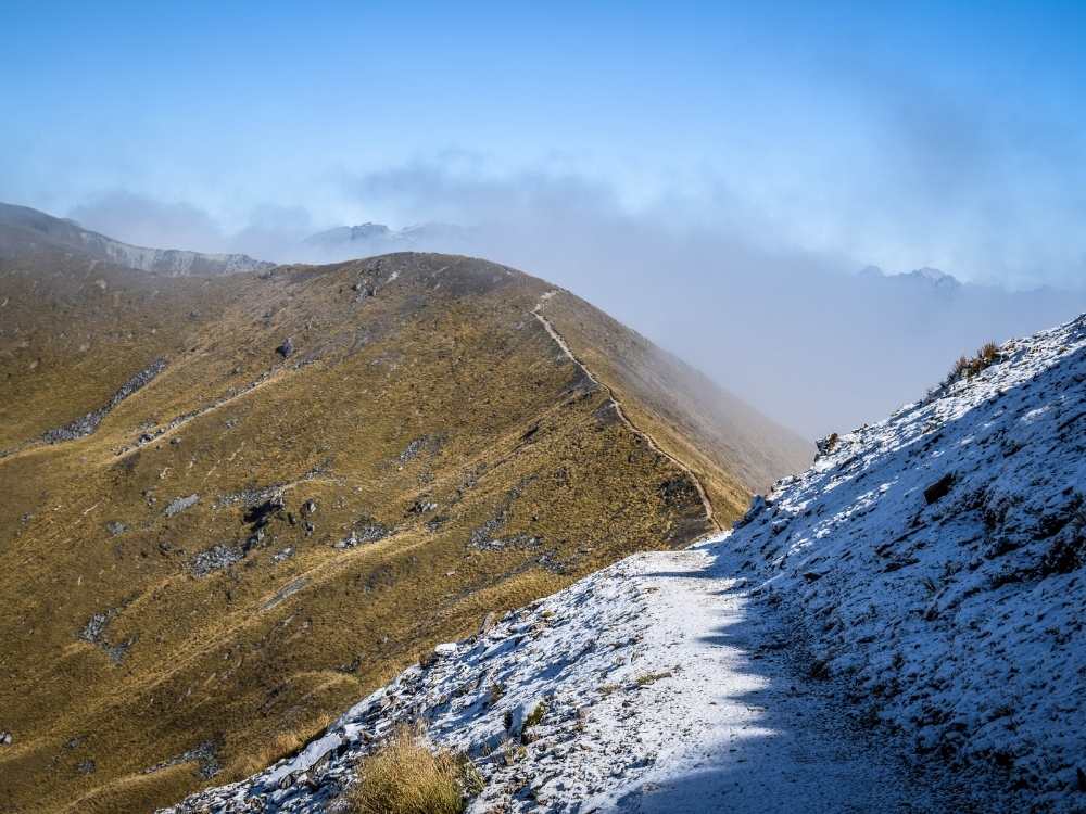 Dock Bay walk with a dusting of snow on the Kepler Track in Fiordland National Park near Te Anau, New Zealand Freewalks.nz