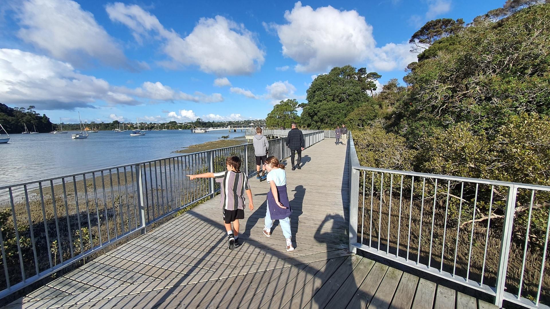 Kids on the boardwalk on the Hobsonville Point Park Loop Walk in Auckland by Freewalks.nz