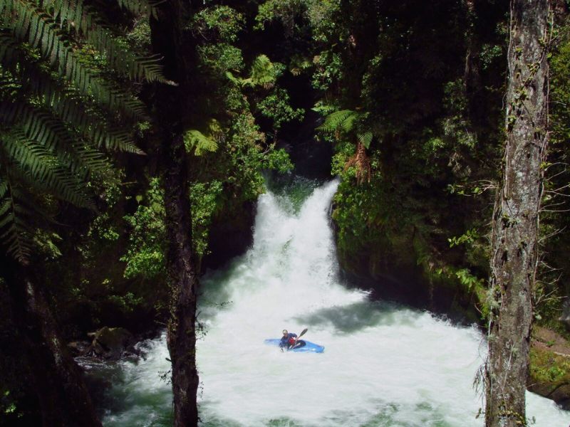 Single man in a kayaka going over the Okere Falls