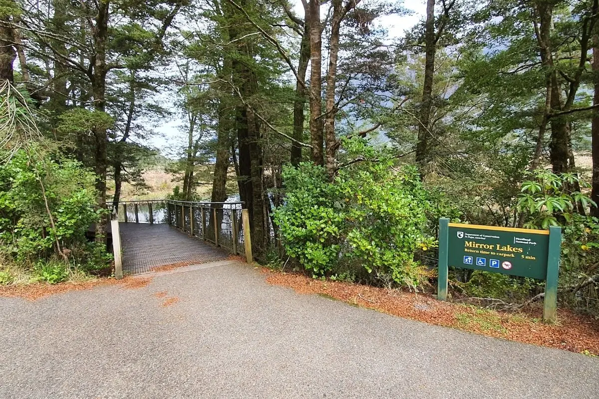 DOC signage and wheelchair accessible boardwalk entrance at Mirror Lakes walk, Fiordland National Park