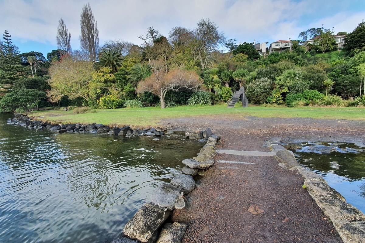 Jetty sticking out from the Orakei Basin Loop Path in Auckland by Freewalks.nz