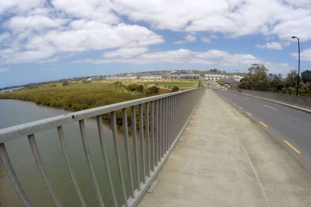 View looking back across the second bridge crossing on the Te Ara Tahuna - Ōrewa Estuary Path just out of Auckland by Freewalks nz