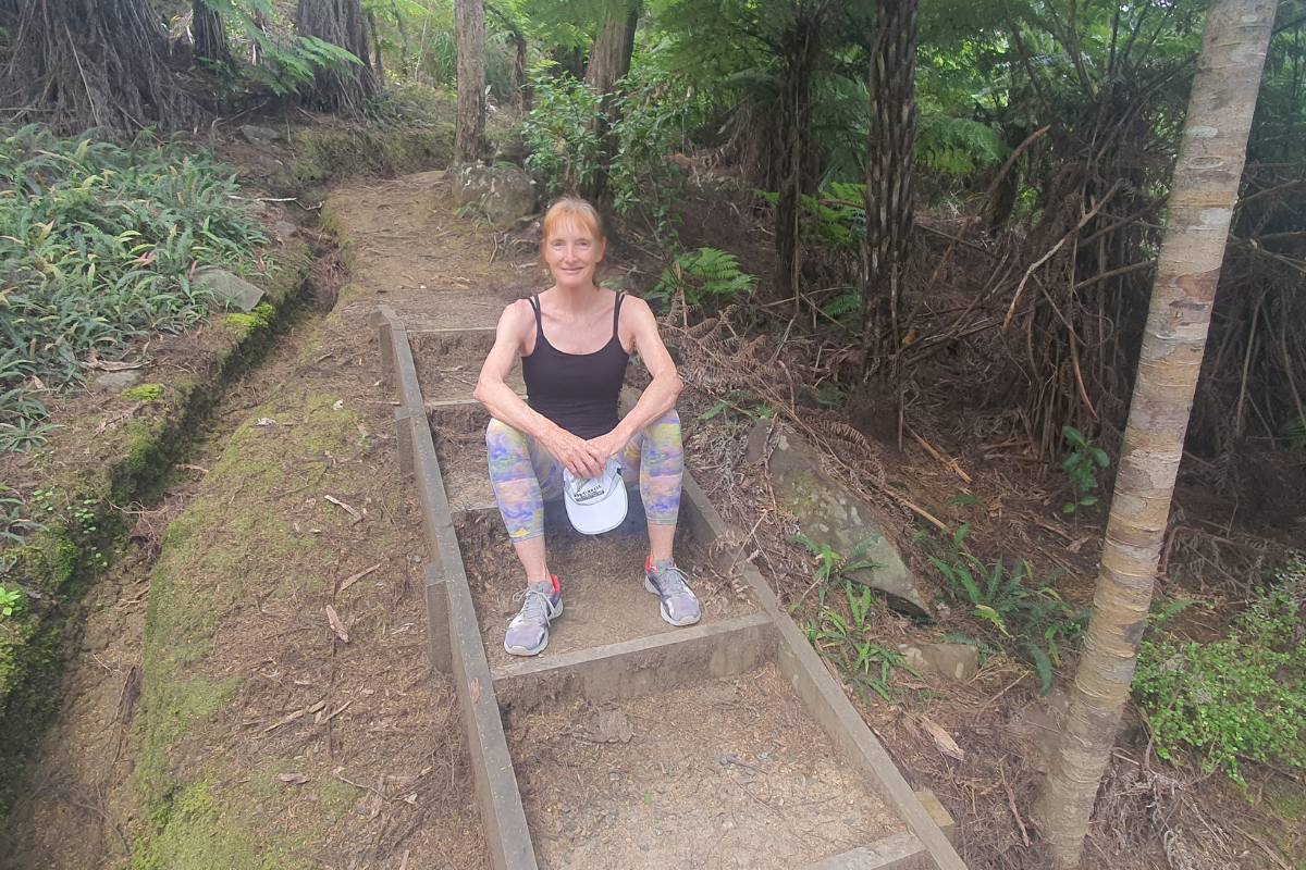 Me sitting on the steps part way along the Bridle Track on Great Barrier Island by Sandra from Freewalks.nz New Zealand