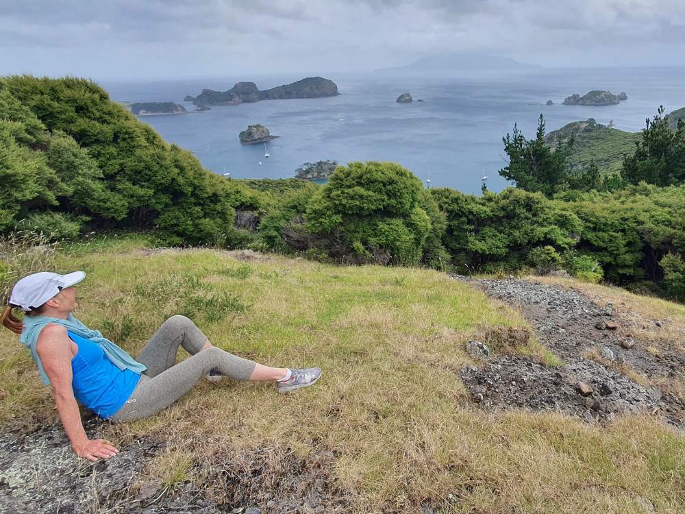 Sandra enjoying the views on the Oneura Bay (Red Cliff Cove). Castle Peak Summit Loop Track on Great Barrier Island by Sandra from Freewalks.nz New Zealand
