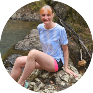 Sandra sitting at Warren's waterfall on Great Barrier Island