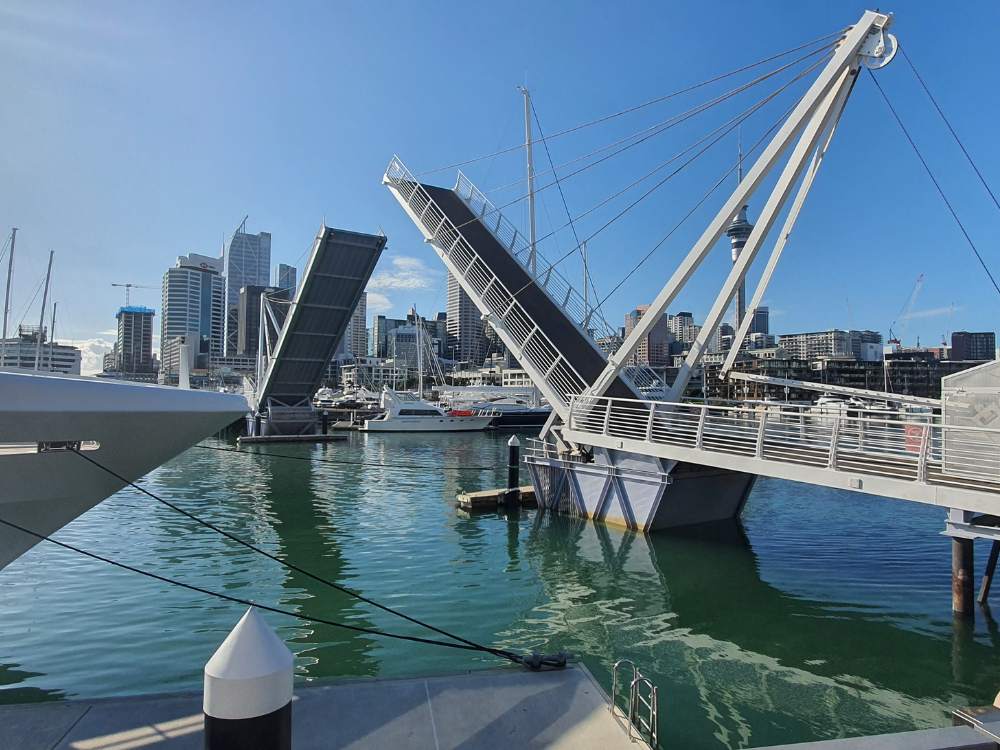 Watching the lifting bridge in the Auckland Viaduct waiting to cross while a boat passes under