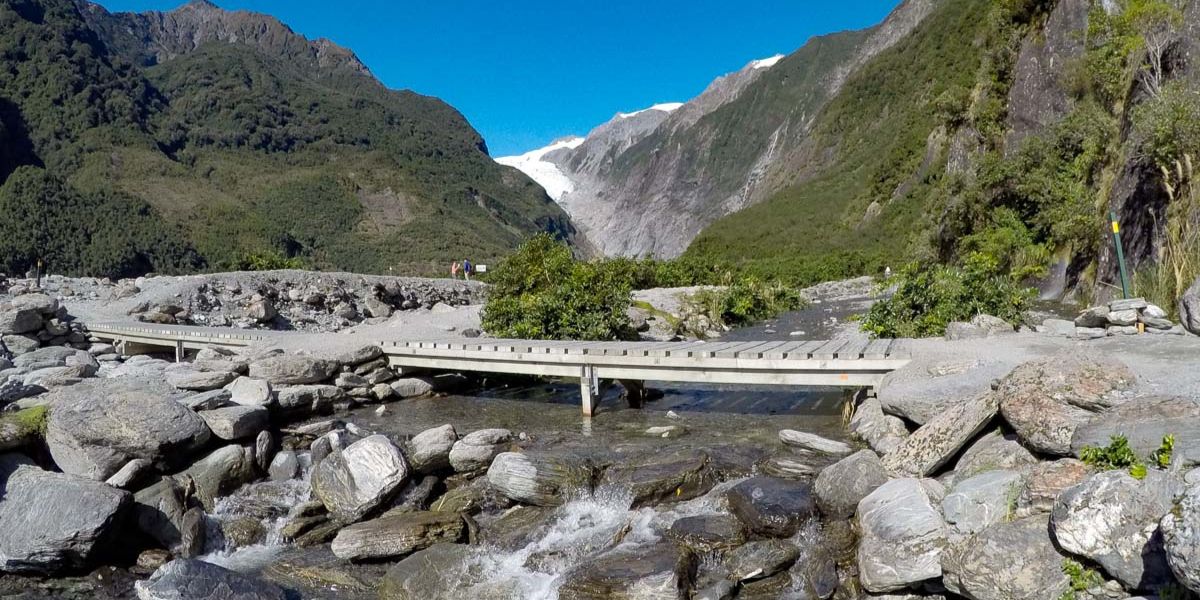 Small bridge with Franz Josef Glacier in the distance