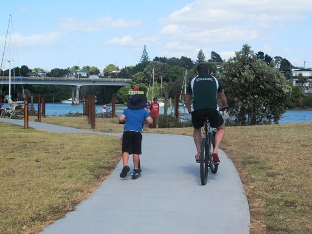a man ride bicycle with his son