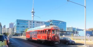 red train with auckland tower backround