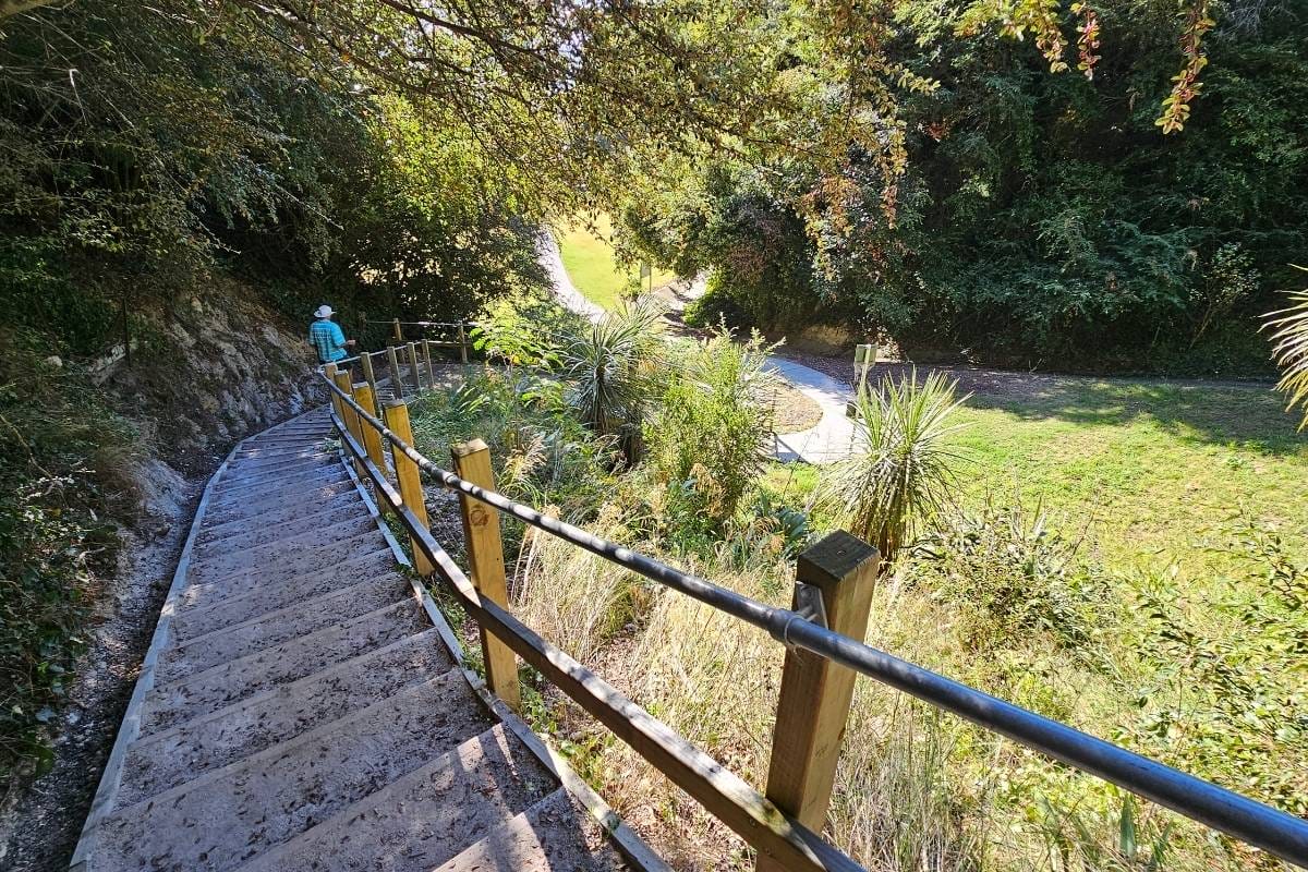 a person walking down a wooden staircase