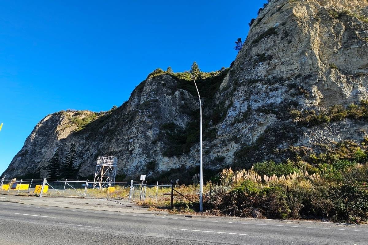a road next to a mountain
