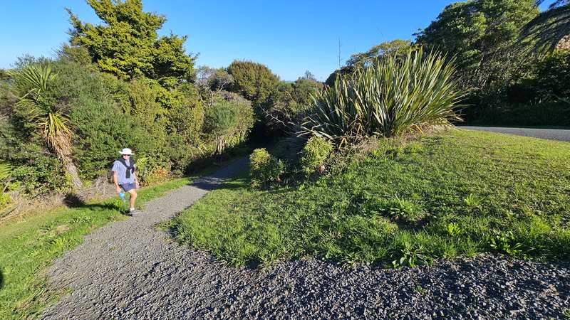 Walker on the gravel path at a track junction