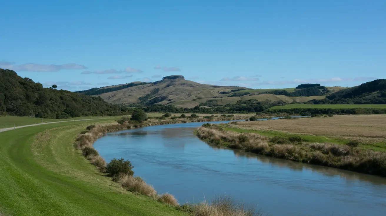 Stunning photograph taken of the Oruawharo River Loop Walk in Warkworth, New Zealand on a bright sunny day, showcasing the natural beauty of the river, lush greenery, and clear blue sky in a realistic style.
