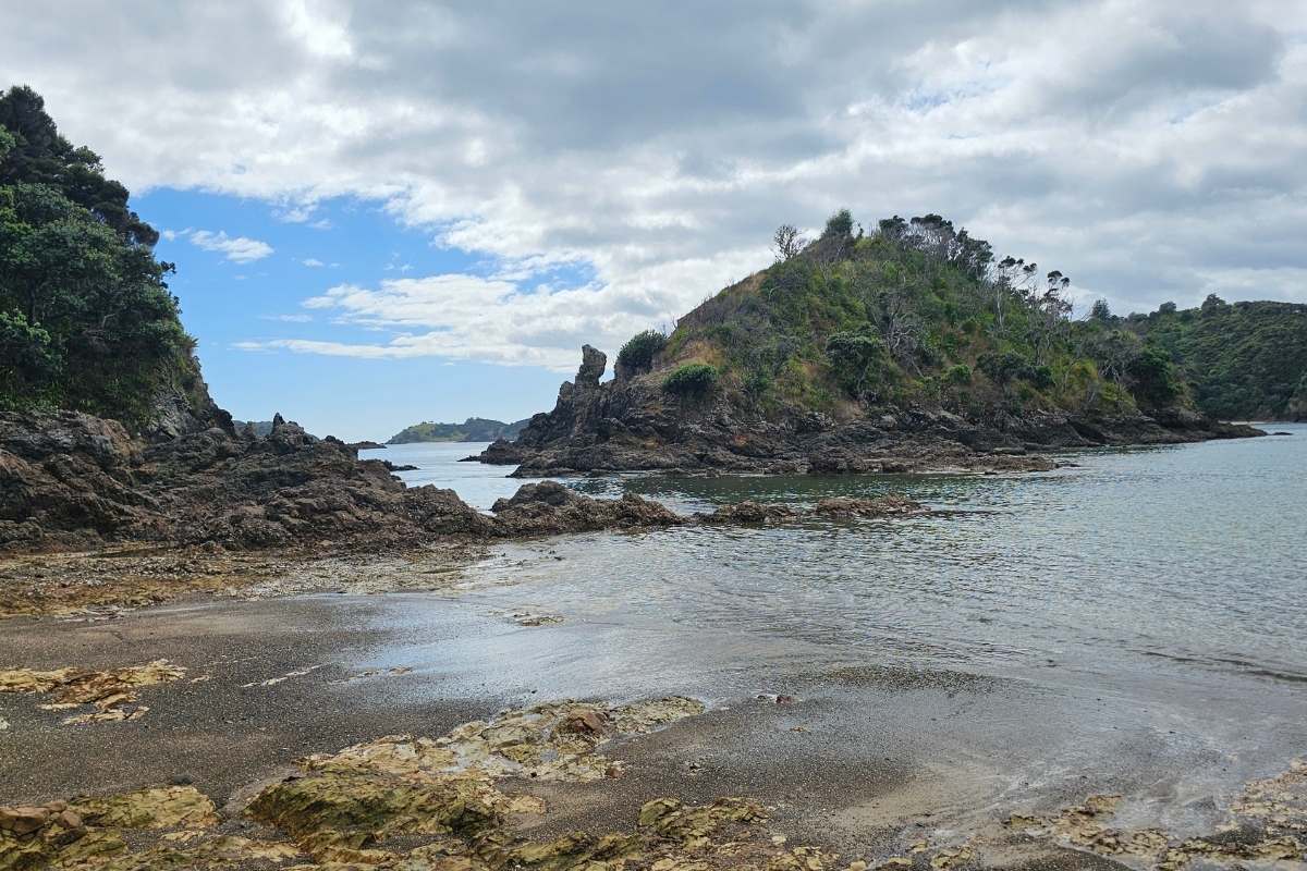 Rocky volcanic coastline with distinctive offshore rock formation