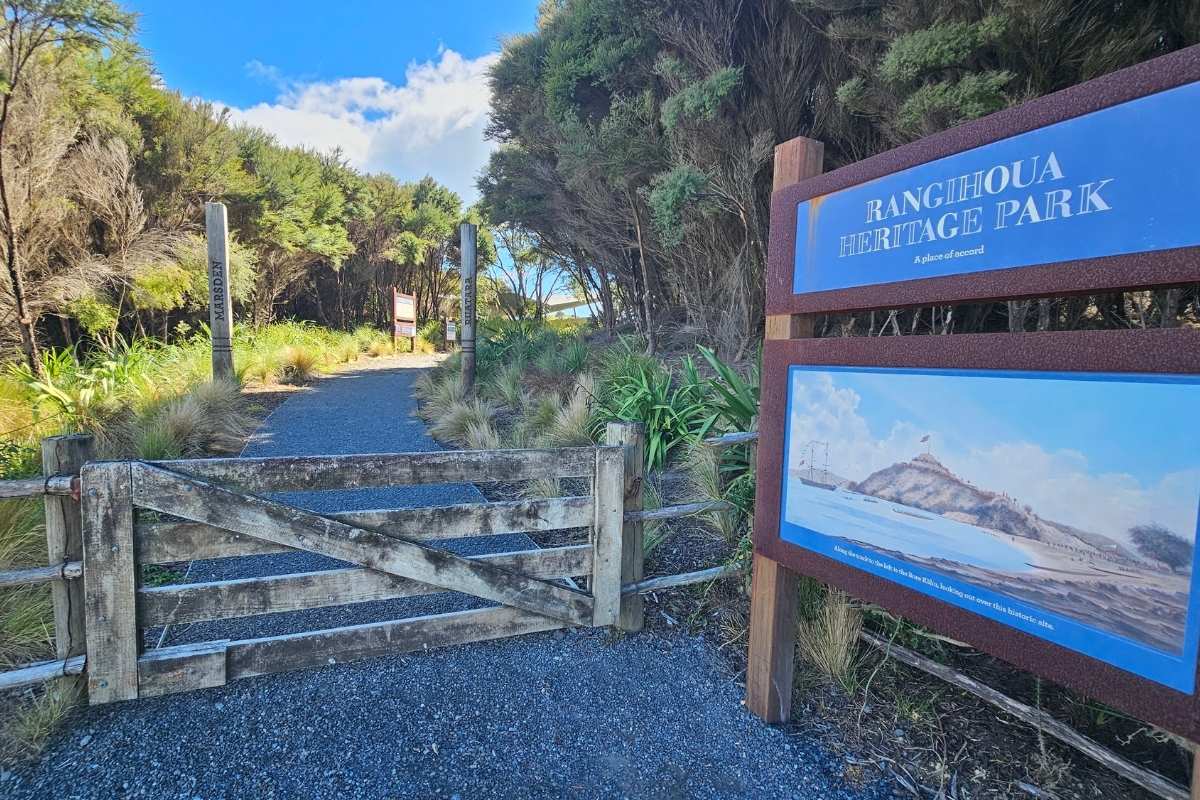 Rangihoua Heritage Park entrance sign and mowed track leading to Marsden Cross Walk