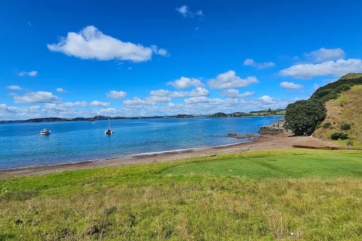 Panoramic view of Rangihoua Bay from Marsden Cross Walk showing turquoise waters and golden beach