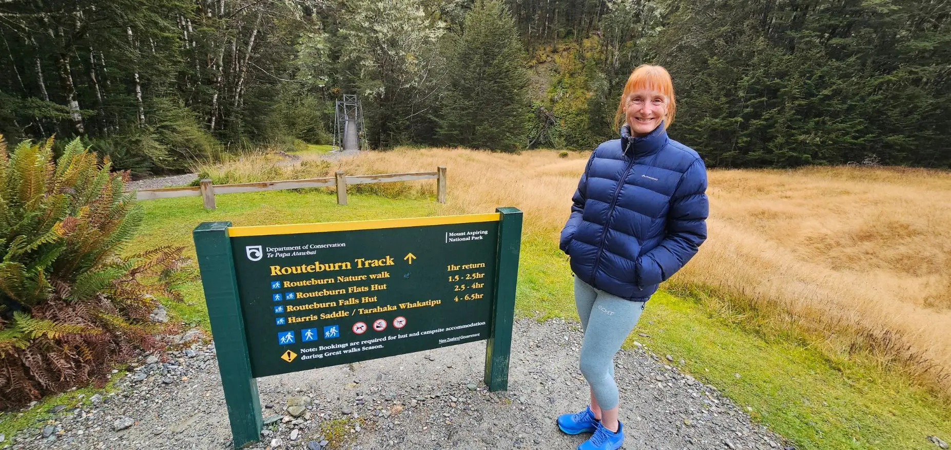 Sandra next to the sign at the beginning of the Routeburn Track