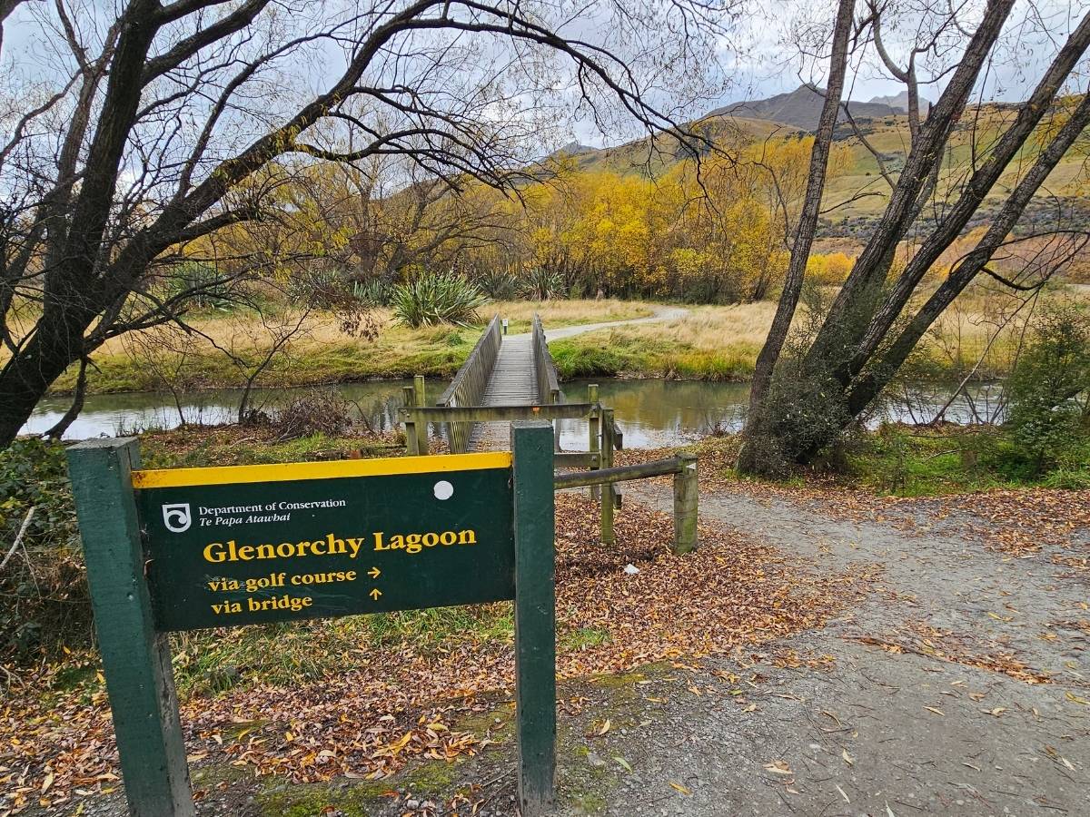 DOC sign at the Glenorchy Lagoon junction showing routes via golf course and via bridge