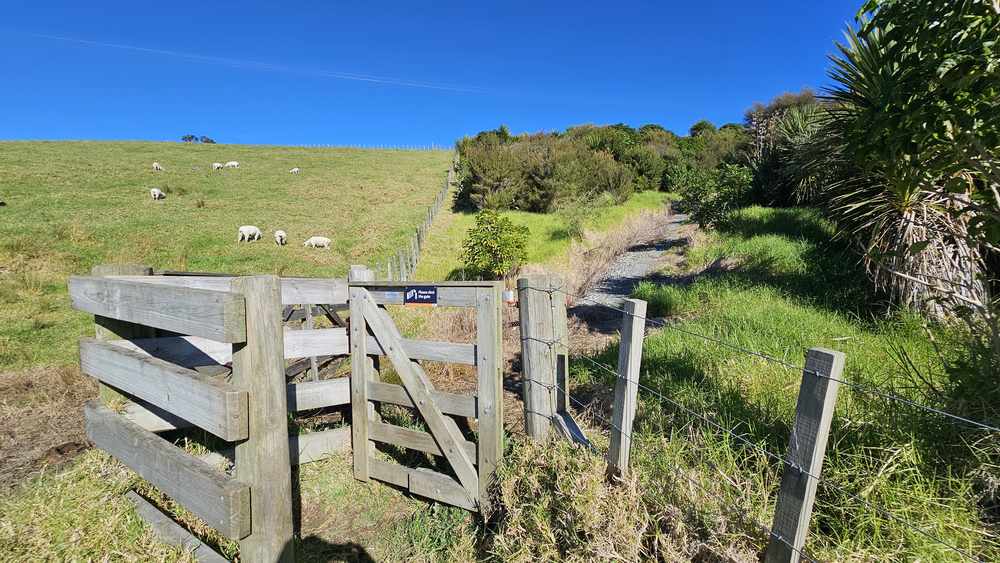 Wooden farm gate and stile on the track