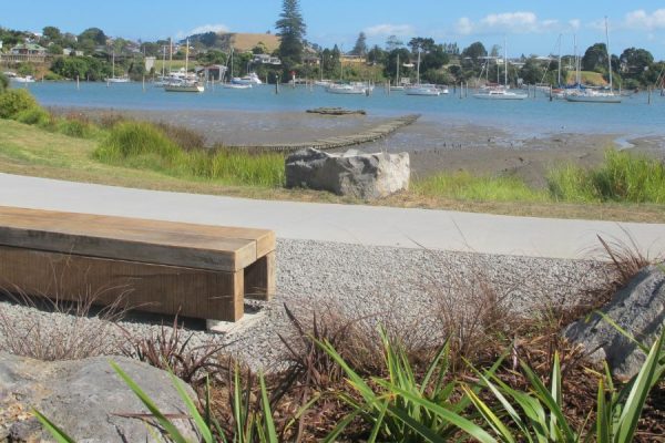 Bench seat on the Pakuranga walkway looking out to the harbour with the boats