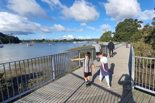 Boardwalk with kids on the Hobsonville Point coastal walkway in West Auckland